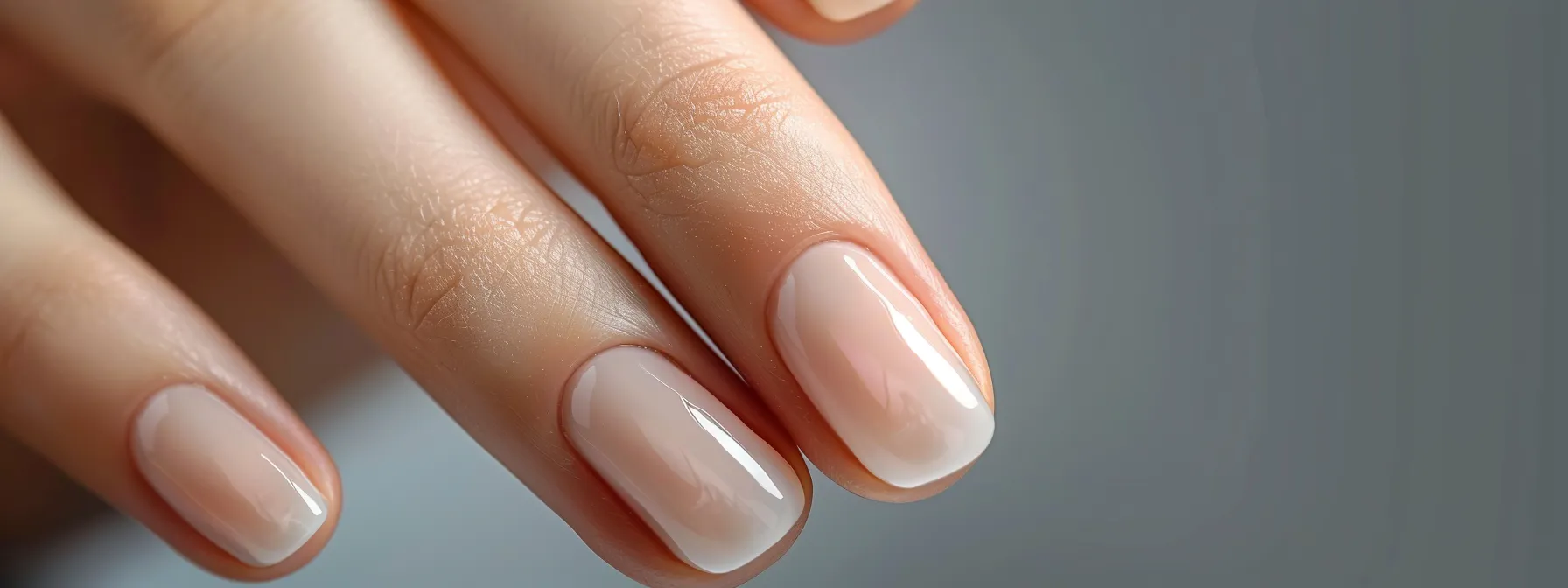 a person admiring their glossy and chip-free nails days after applying water-based nail polish.