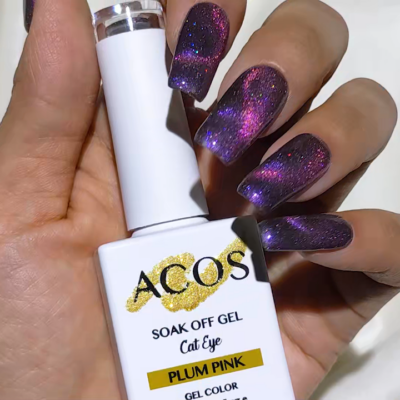 Hand holding ACOS Soak Off Gel Cat Eye nail polish in Plum Pink with glittery purple and pink cat eye nails.