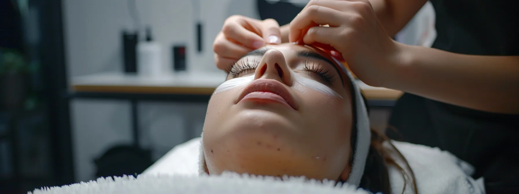 a woman receiving a patch test for eyelash extensions at a beauty salon.